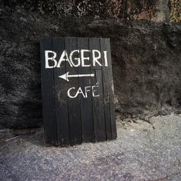 svart skylt med vit text, cafe bageri