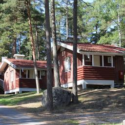 A row of three red cottages at Naantali Camping.