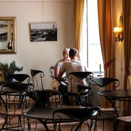 The elegant interior of Cafe Art, featuring French-style tables and chairs.